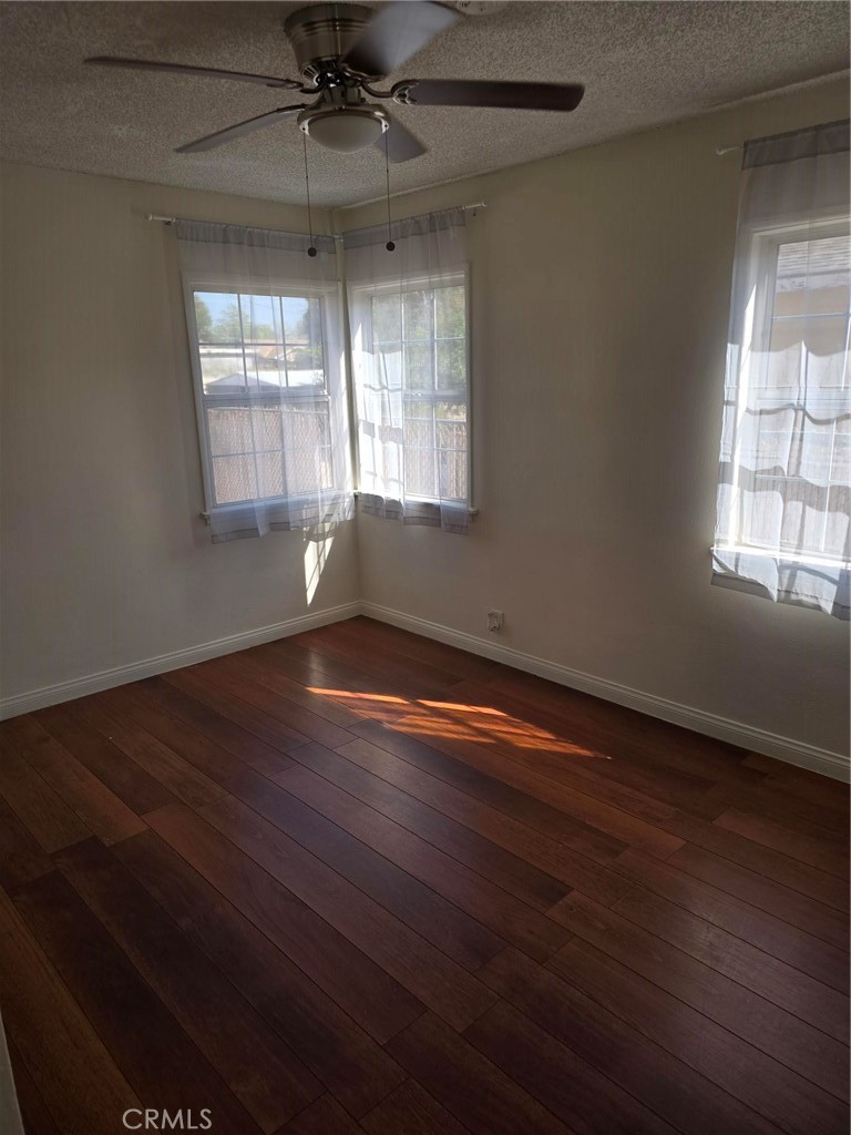 5379 35th Street Riverside, CA 92509 - Photo 8 of 10 an empty room with wooden floor and windows