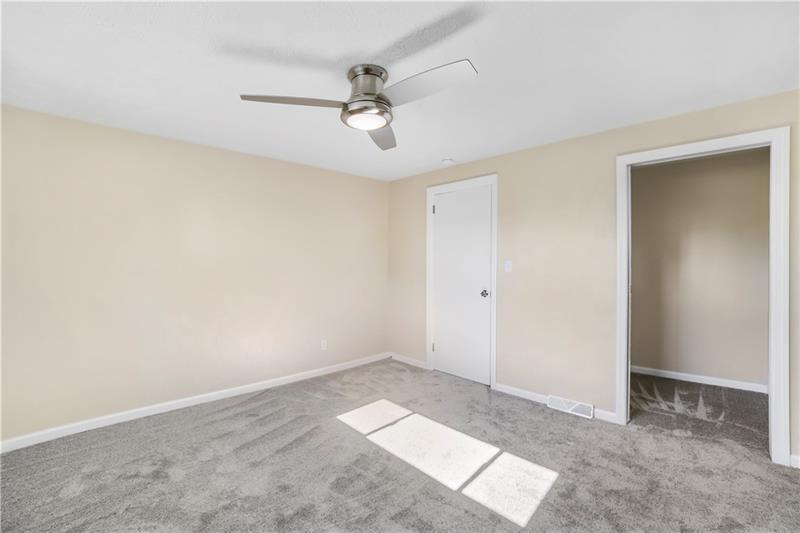 112 Roberts Clairton, PA 15025 - Photo 5 of 8 an empty room with a ceiling fan and a window