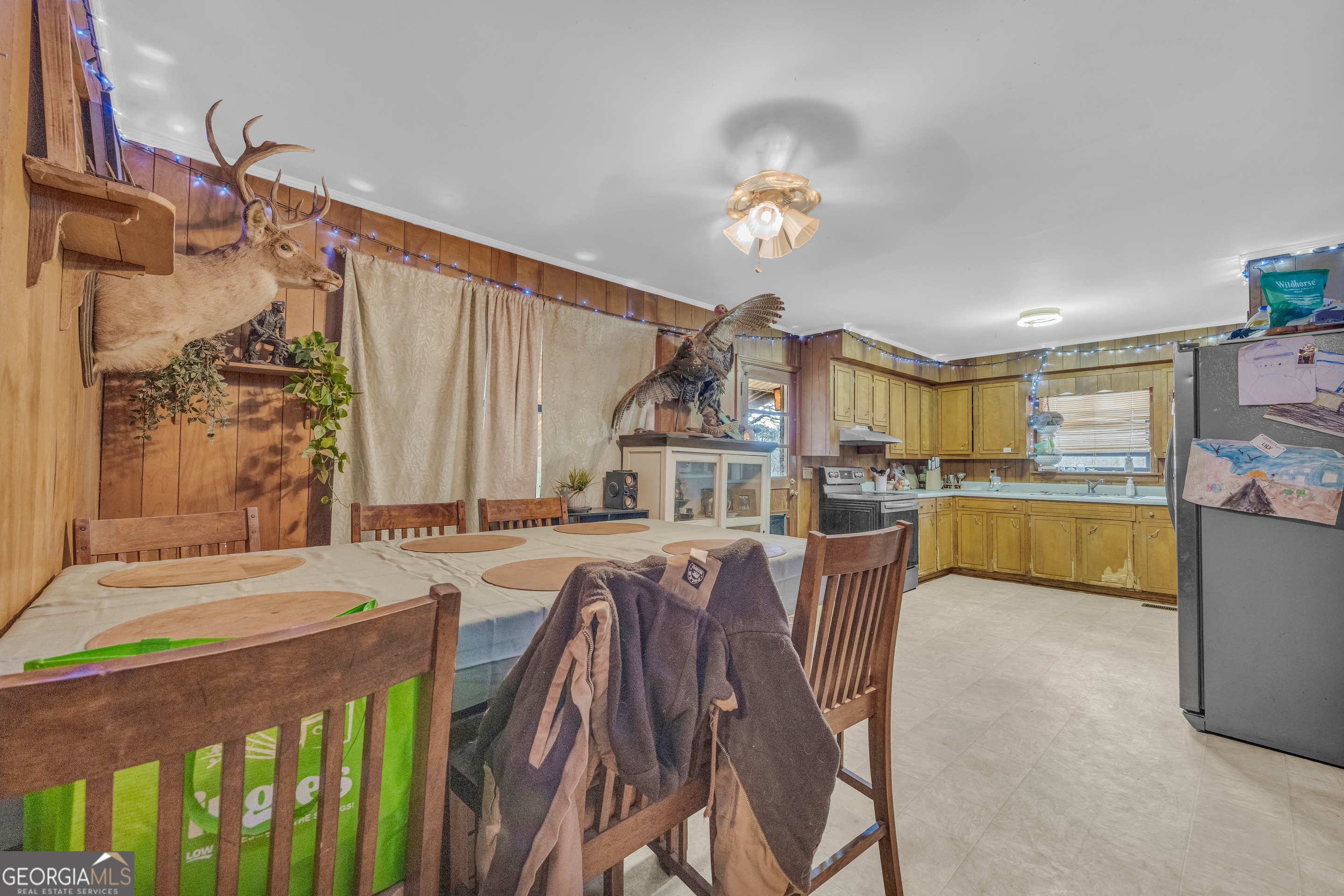 787 Parham Town Road Bowman, GA 30624 - Photo 29 of 49 a view of a dining room and livingroom with furniture wooden floor a chandelier