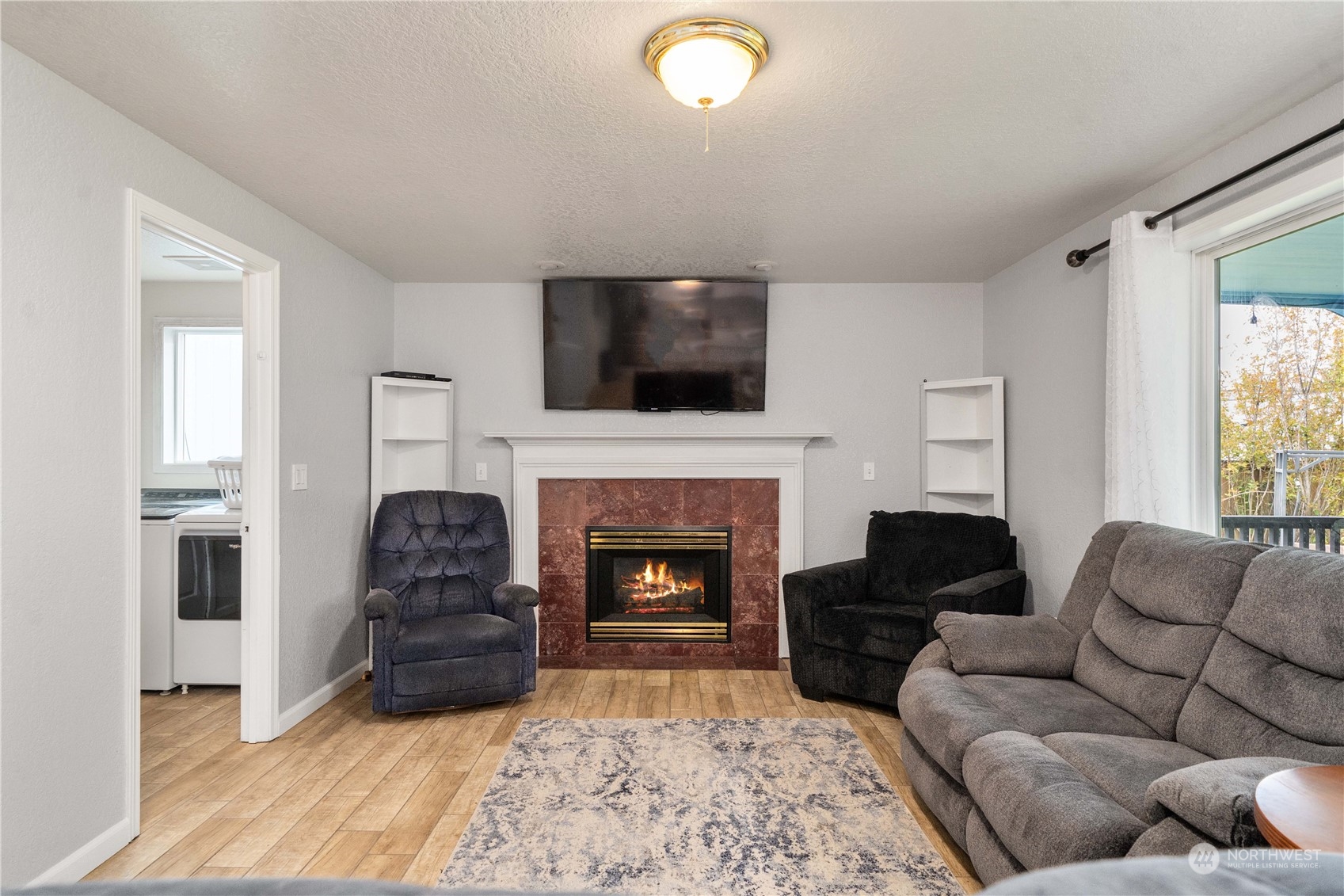 5911 Compton Loop Southeast Lacey, WA 98513 - Photo 12 of 32 a living room with furniture a flat screen tv and a fireplace