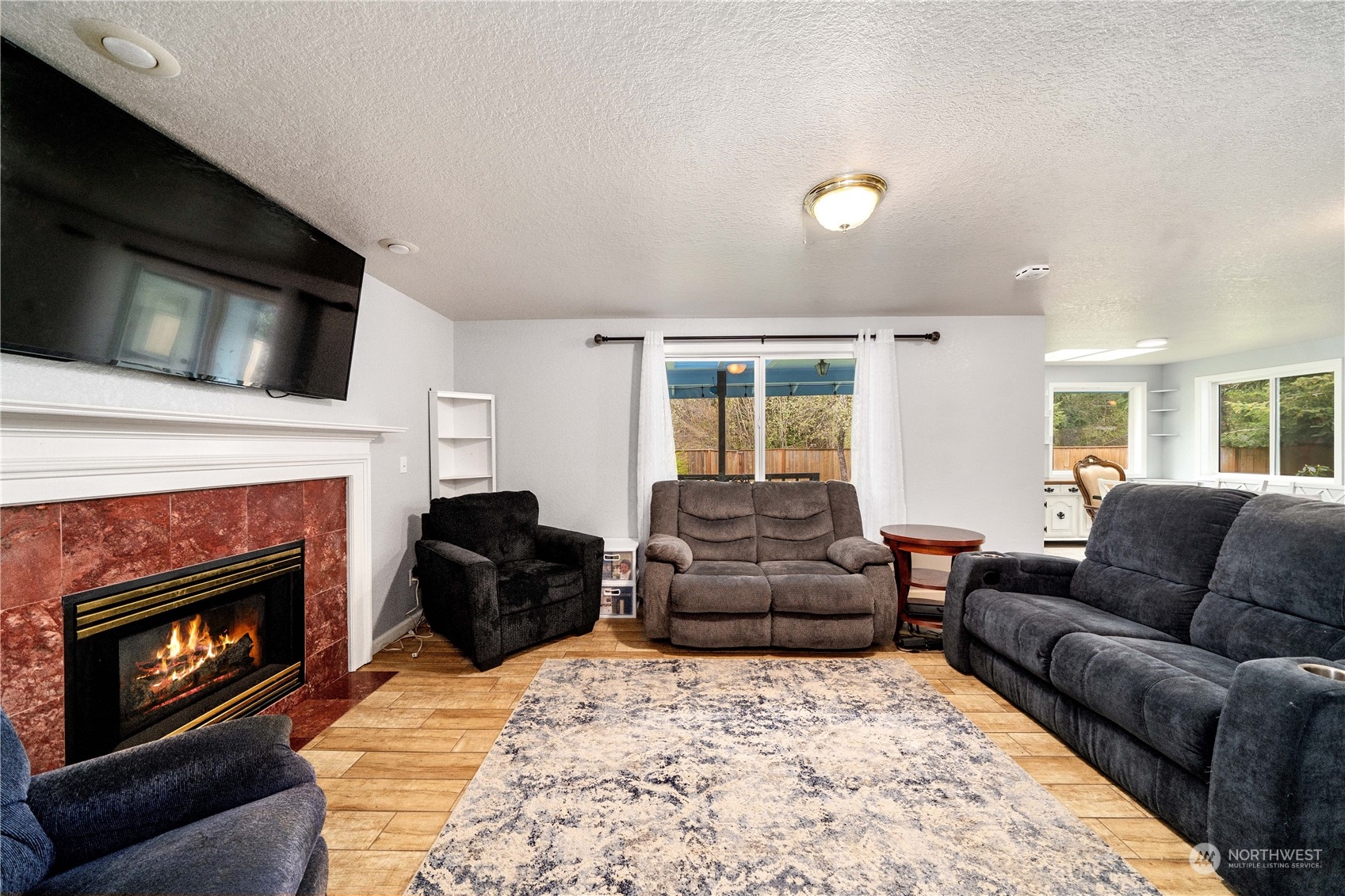 5911 Compton Loop Southeast Lacey, WA 98513 - Photo 13 of 32 a living room with furniture a flat screen tv and a fireplace