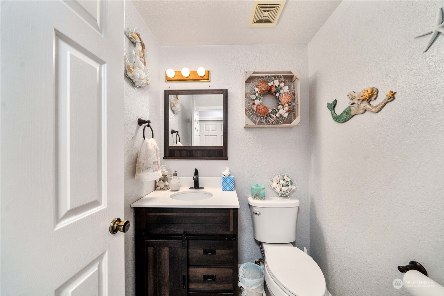 5911 Compton Loop Southeast Lacey, WA 98513 - Photo 15 of 32 a bathroom with a toilet a sink and mirror
