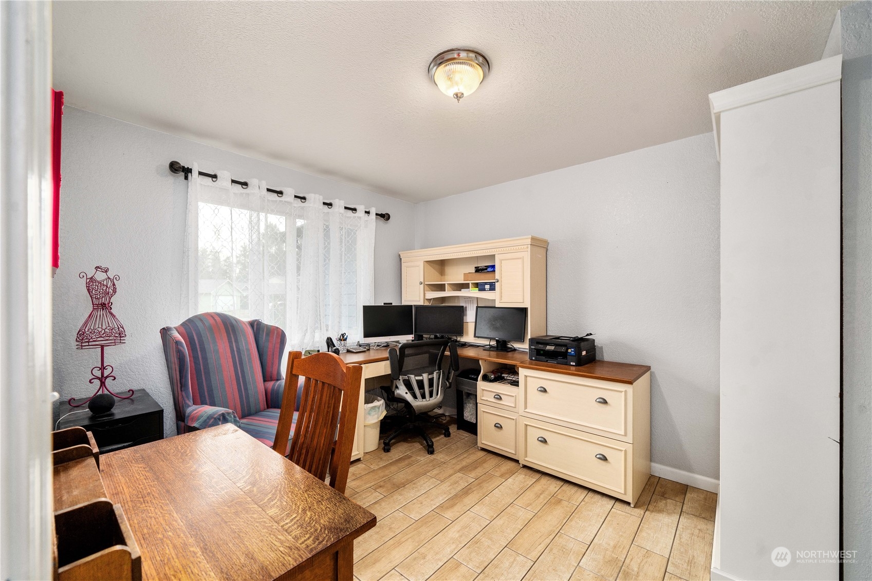 5911 Compton Loop Southeast Lacey, WA 98513 - Photo 16 of 32 a work room with furniture and a wooden floor