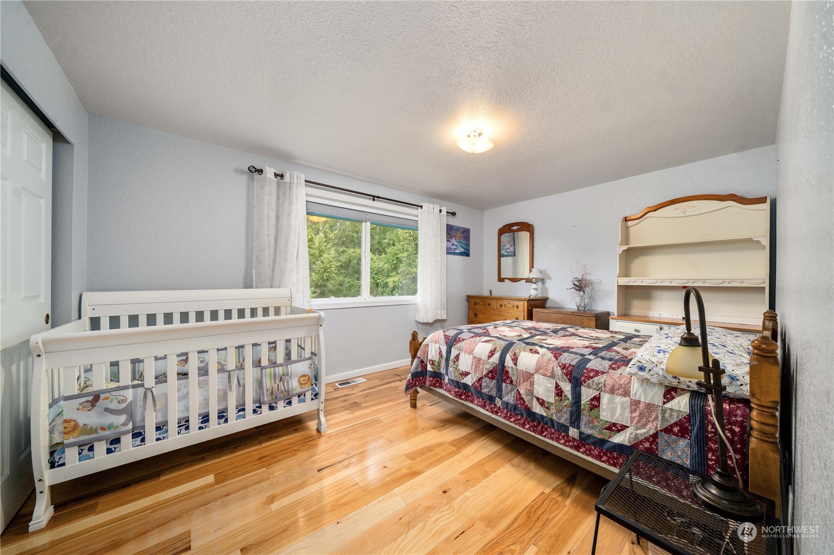 5911 Compton Loop Southeast Lacey, WA 98513 - Photo 17 of 32 a bed sitting in a bedroom next to a window