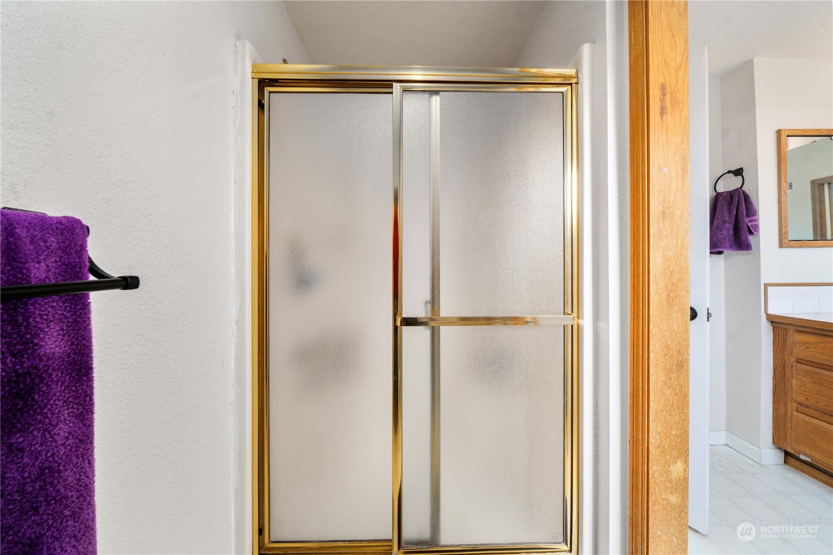 5911 Compton Loop Southeast Lacey, WA 98513 - Photo 22 of 32 a bathroom with a glass shower door