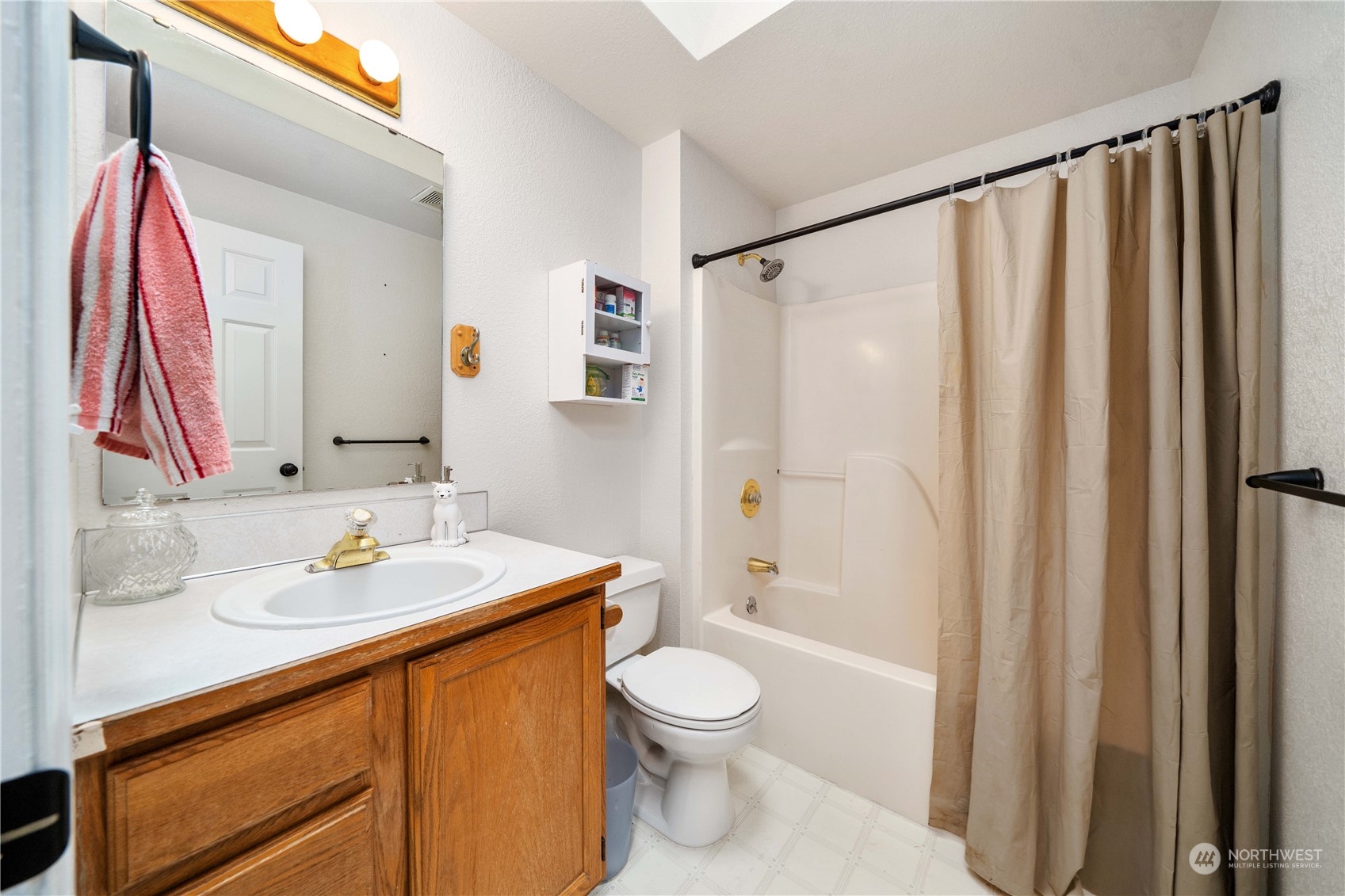 5911 Compton Loop Southeast Lacey, WA 98513 - Photo 23 of 32 a bathroom with a sink a toilet and shower