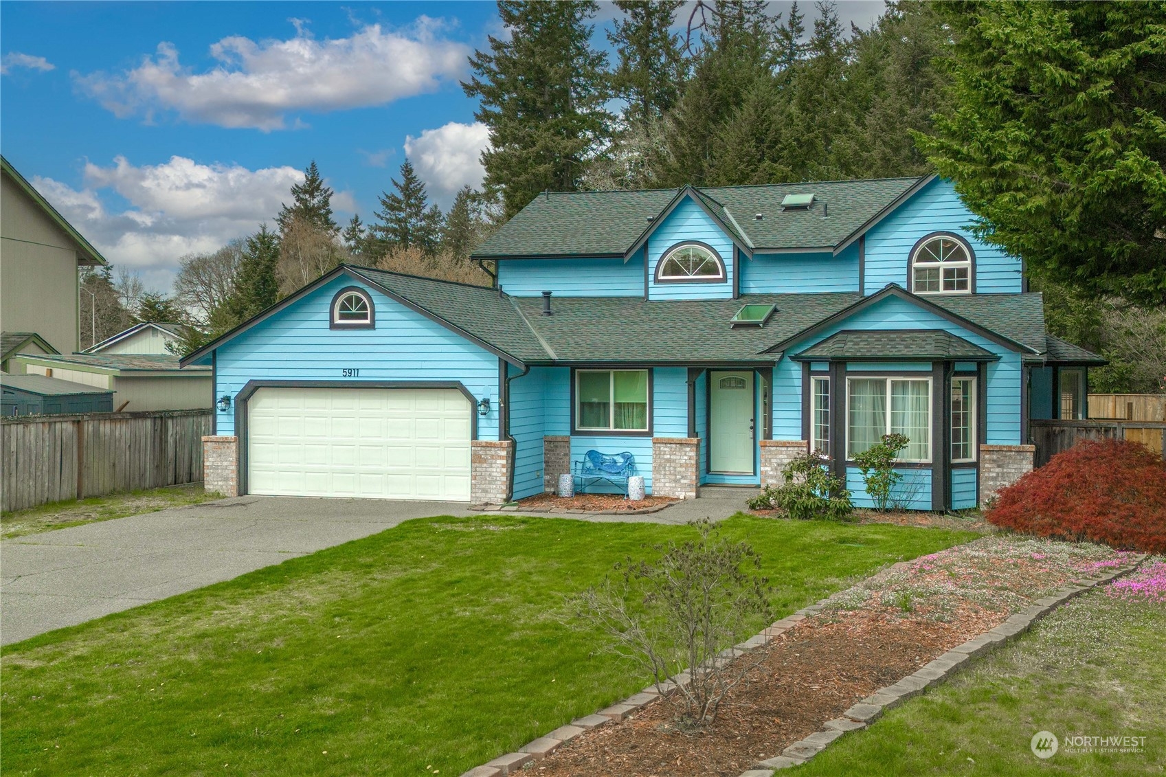 5911 Compton Loop Southeast Lacey, WA 98513 - Photo 24 of 32 a front view of a house with a yard and garage