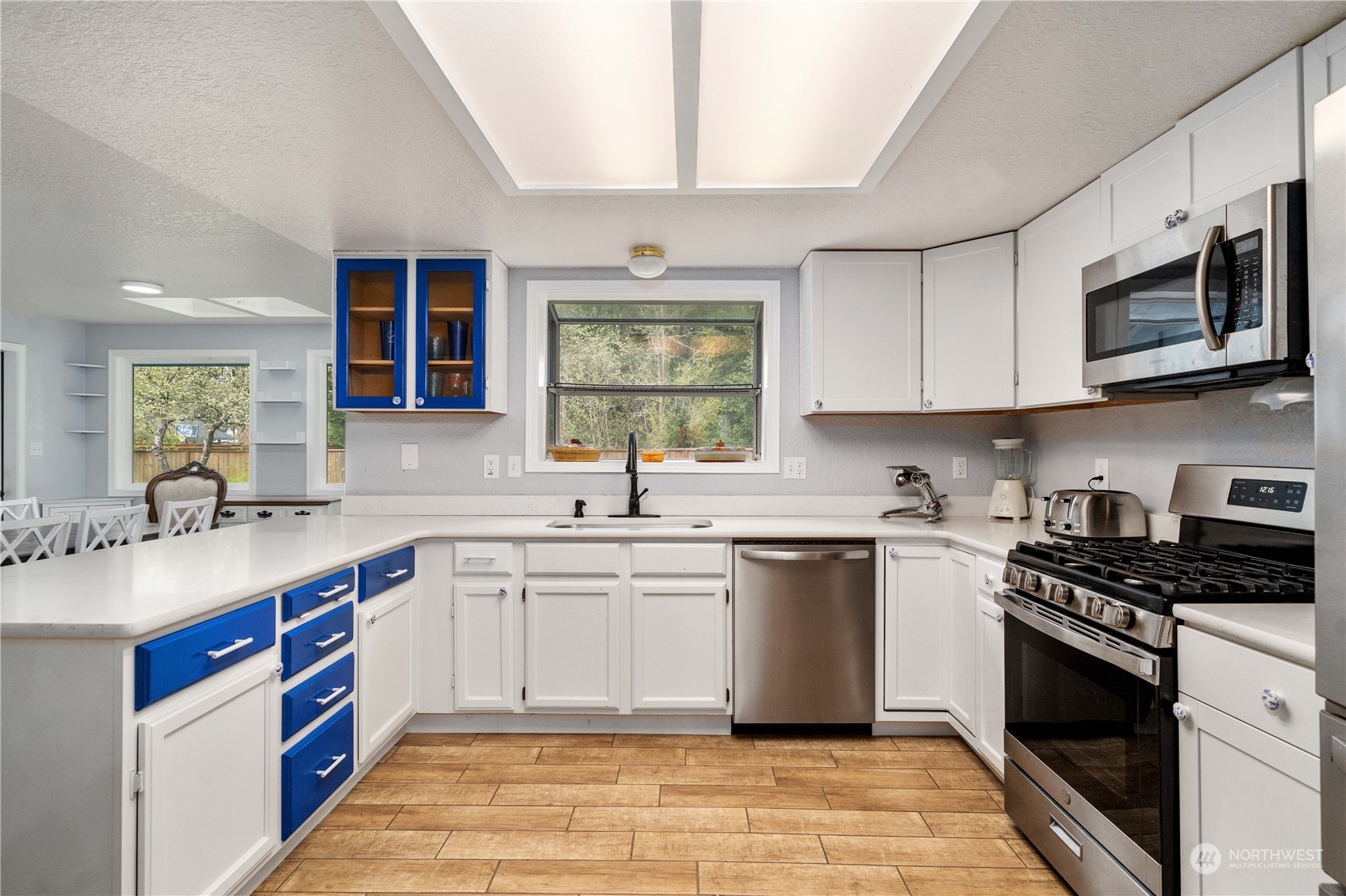 5911 Compton Loop Southeast Lacey, WA 98513 - Photo 8 of 32 a kitchen with stainless steel appliances granite countertop a stove sink microwave and cabinets