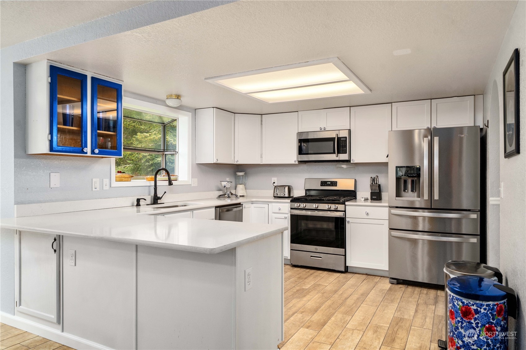 5911 Compton Loop Southeast Lacey, WA 98513 - Photo 9 of 32 a kitchen with stainless steel appliances a refrigerator sink and microwave
