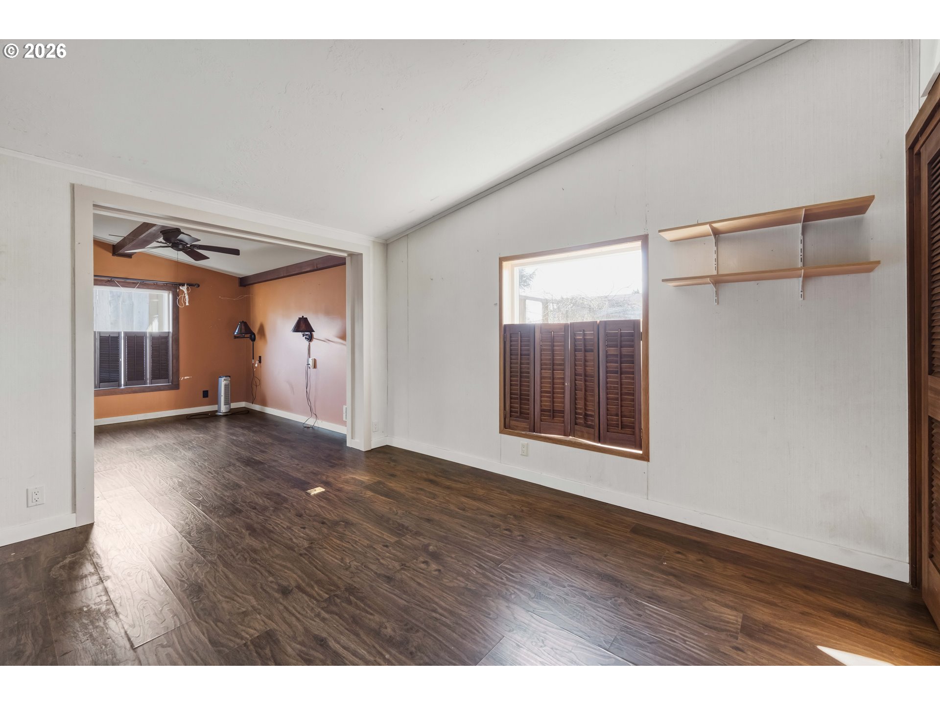 1030 June Avenue Southeast Bandon, OR 97411 - Photo 11 of 43 a view of an empty room with wooden floor and a window