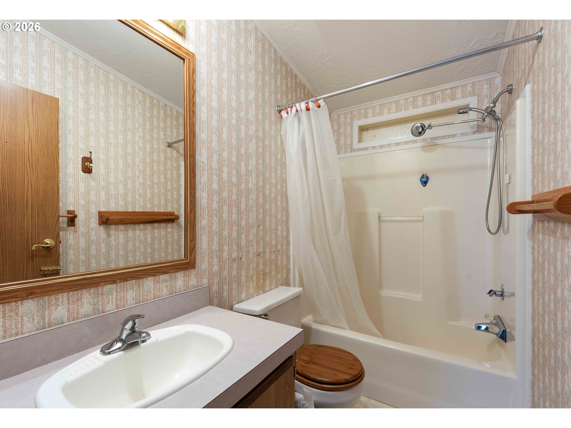 1030 June Avenue Southeast Bandon, OR 97411 - Photo 15 of 43 a bathroom with a sink and a mirror
