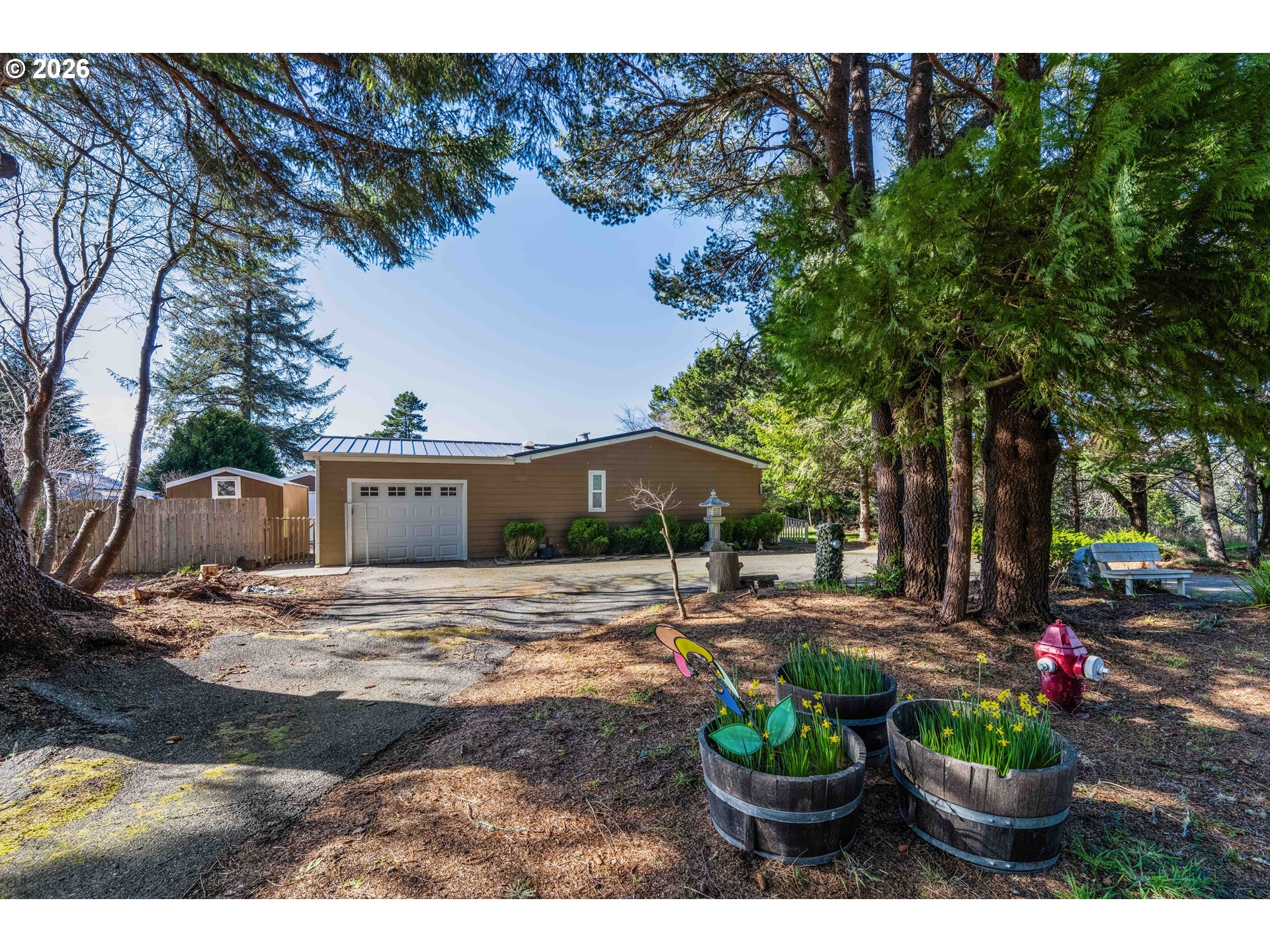 1030 June Avenue Southeast Bandon, OR 97411 - Photo 2 of 43 a view of a backyard with a patio