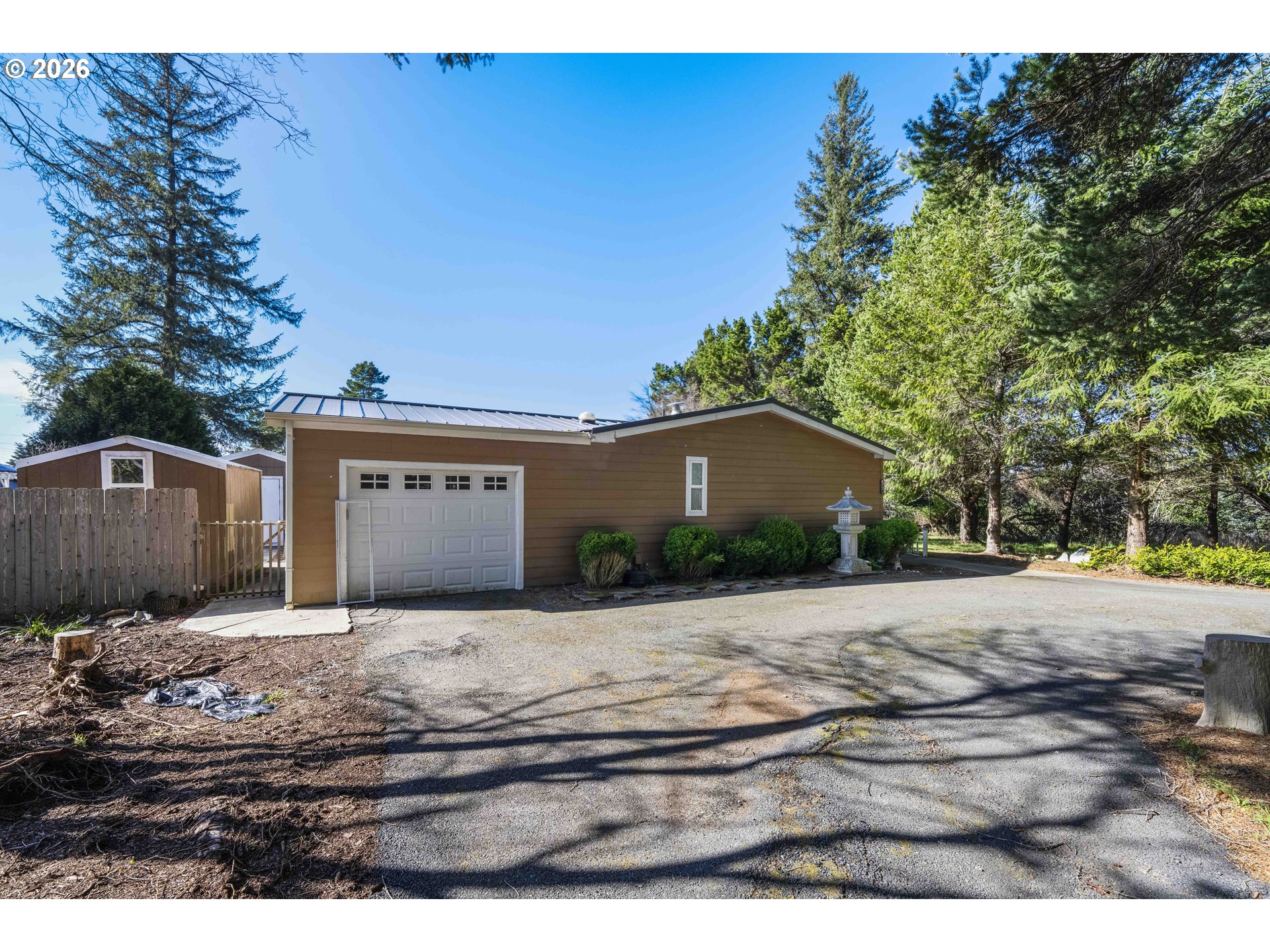 1030 June Avenue Southeast Bandon, OR 97411 - Photo 25 of 43 a front view of a house with a yard