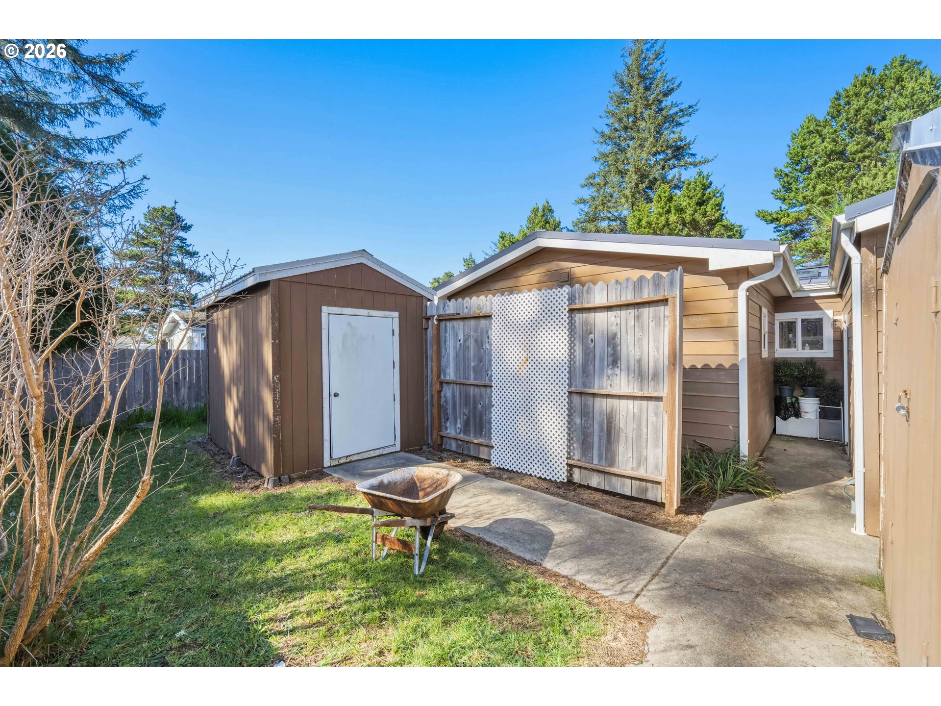 1030 June Avenue Southeast Bandon, OR 97411 - Photo 28 of 43 a backyard of a house with table and chairs