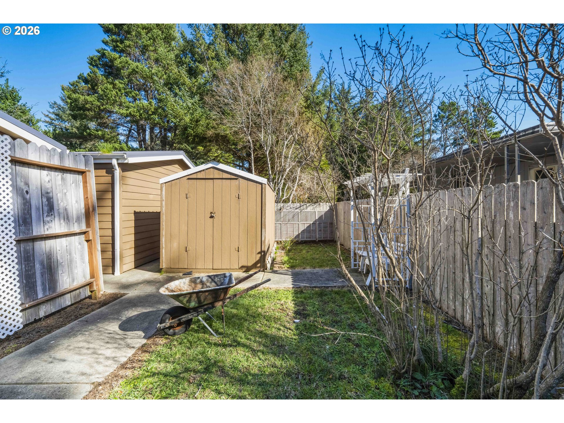 1030 June Avenue Southeast Bandon, OR 97411 - Photo 29 of 43 a backyard of a house with table and chairs