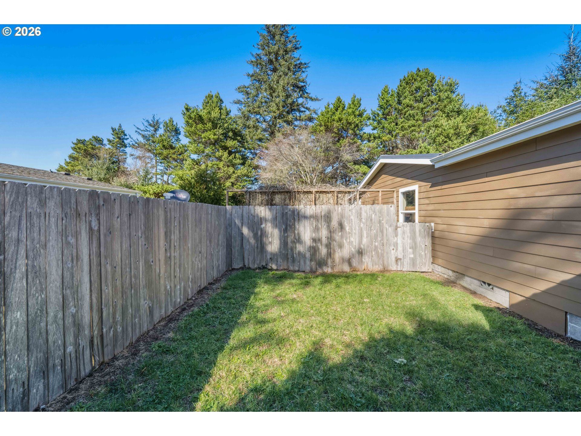 1030 June Avenue Southeast Bandon, OR 97411 - Photo 30 of 43 a view of a backyard with a garden