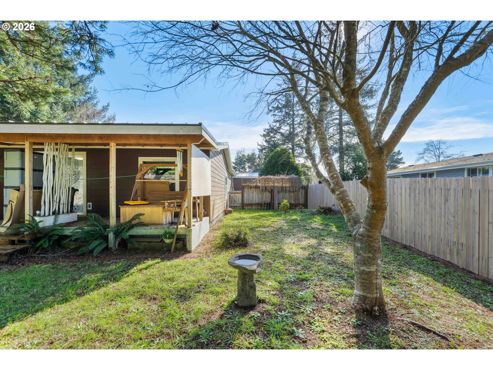 1030 June Avenue Southeast Bandon, OR 97411 - Photo 33 of 43 a backyard of a house with seating space