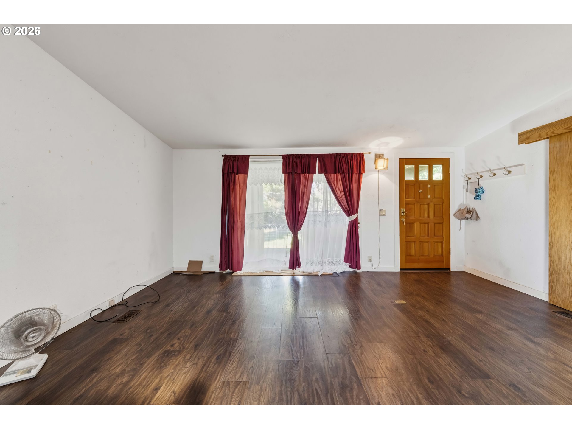 1030 June Avenue Southeast Bandon, OR 97411 - Photo 4 of 43 a view of an empty room with wooden floor and a painting