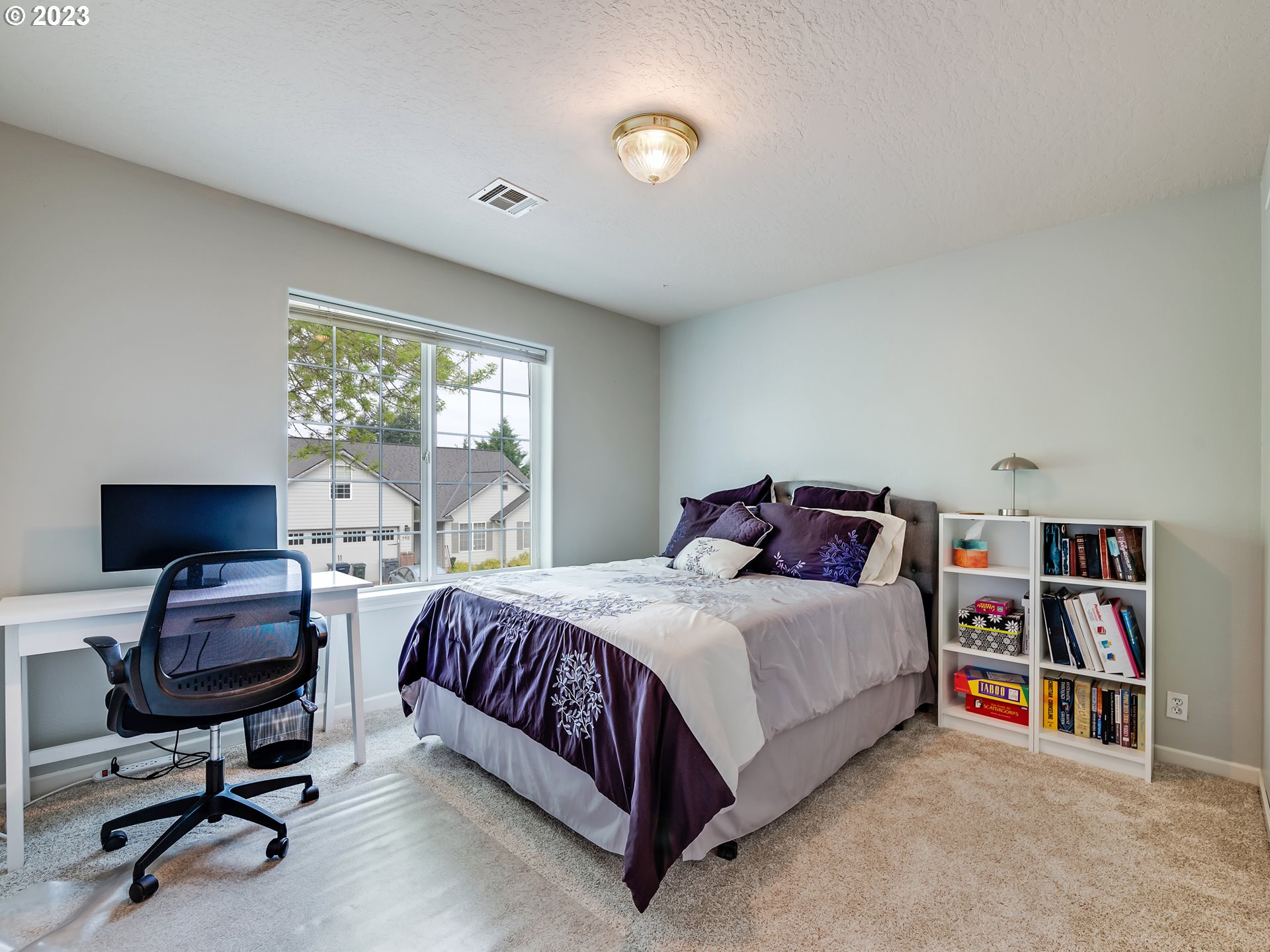939 65th Place Springfield, OR 97478 - Photo 27 of 36 a bedroom with a bed a desk and book shelfs