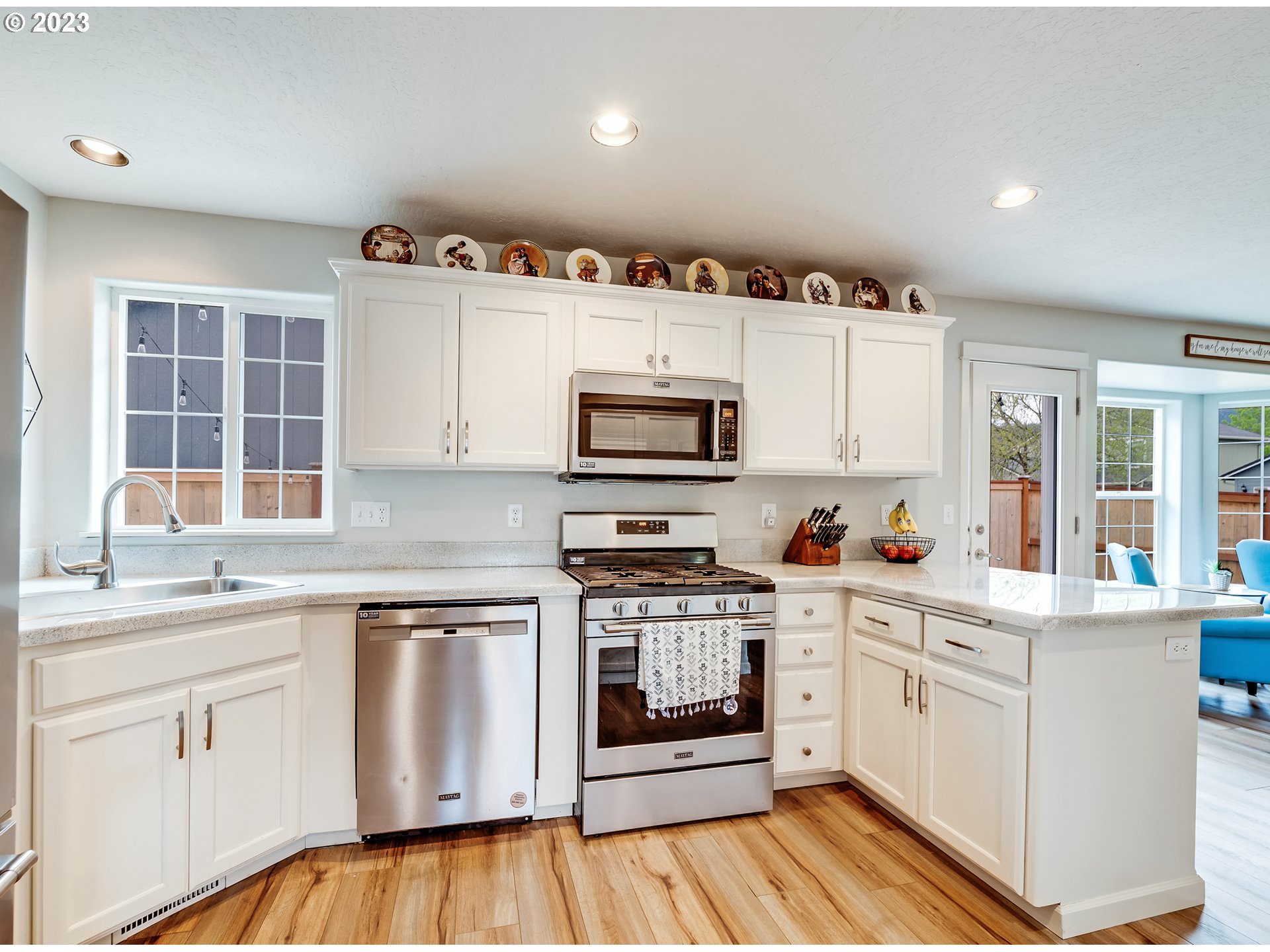 939 65th Place Springfield, OR 97478 - Photo 9 of 36 a kitchen with granite countertop white cabinets and white appliances