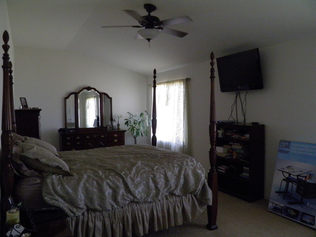 3090 Patterson Road Montgomery, IL 60538 - Photo 14 of 14 a bedroom with a bed tv and a window