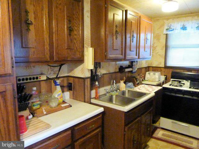 304 Miles Road Baltimore, MD 21221 - Photo 2 of 19 a kitchen with a sink and a cabinets