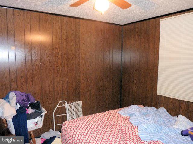 304 Miles Road Baltimore, MD 21221 - Photo 11 of 19 a bedroom with a bed and a table