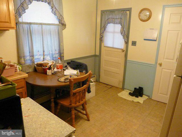 304 Miles Road Baltimore, MD 21221 - Photo 13 of 19 a dining room with furniture and a window
