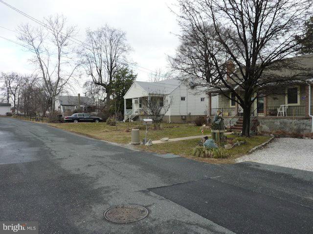 304 Miles Road Baltimore, MD 21221 - Photo 17 of 19 a view of a white house with a yard covered with snow