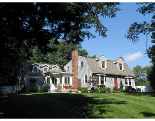 a front view of house with yard and green space