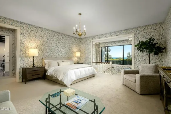 a bedroom with a bed and a fireplace