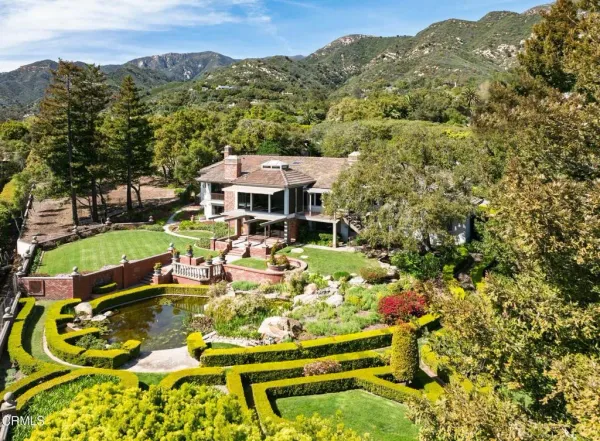 an aerial view of a house with a yard and swimming pool