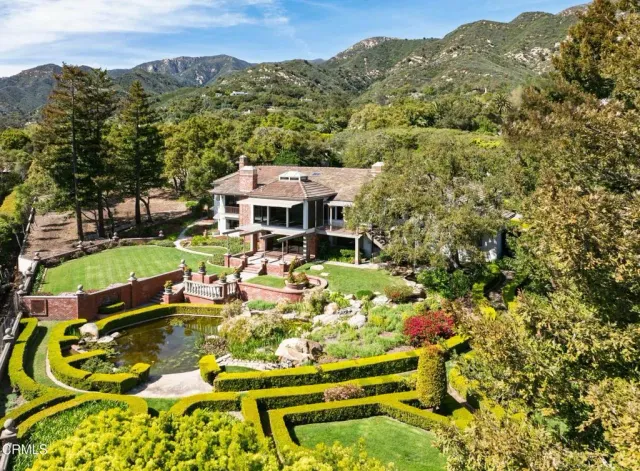 an aerial view of a house with a yard and swimming pool