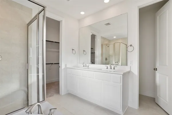 a bathroom with a double vanity sink mirror and double