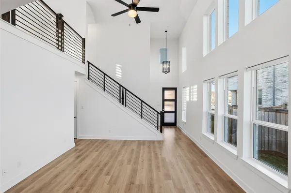 a view of staircase with lots of frames and wooden floor