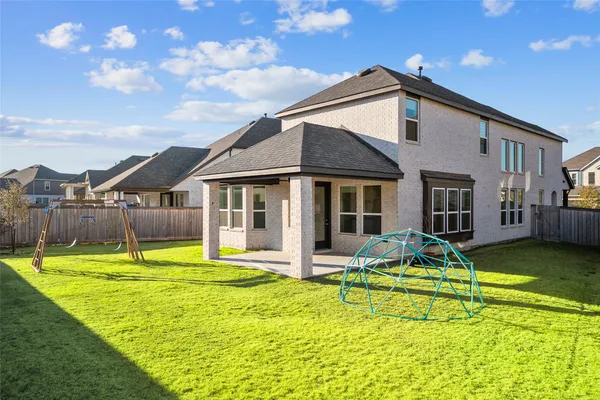 a view of a house with swimming pool and yard
