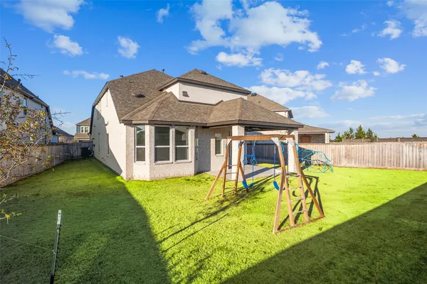 a view of a house with a yard patio and swimming pool