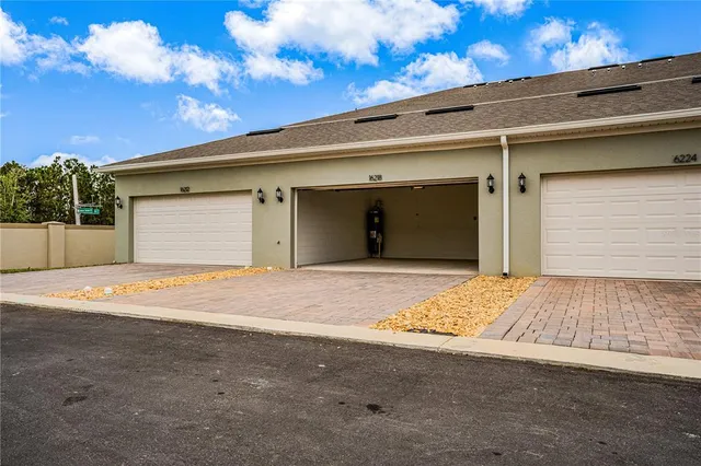 a view of kitchen with kitchen island wooden floor center island and stainless steel appliances
