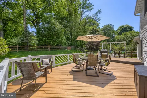 a view of a roof deck with table and chairs under an umbrella