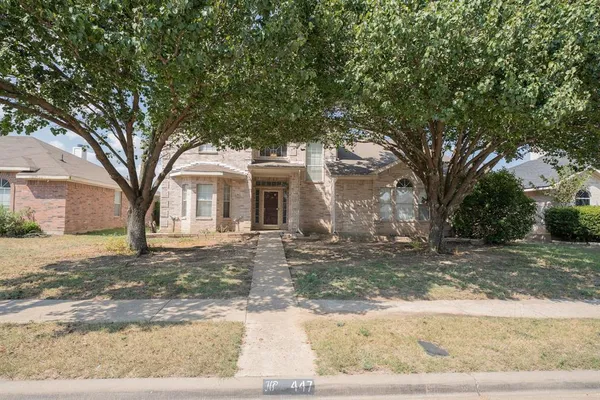 a view of a yard with a tree