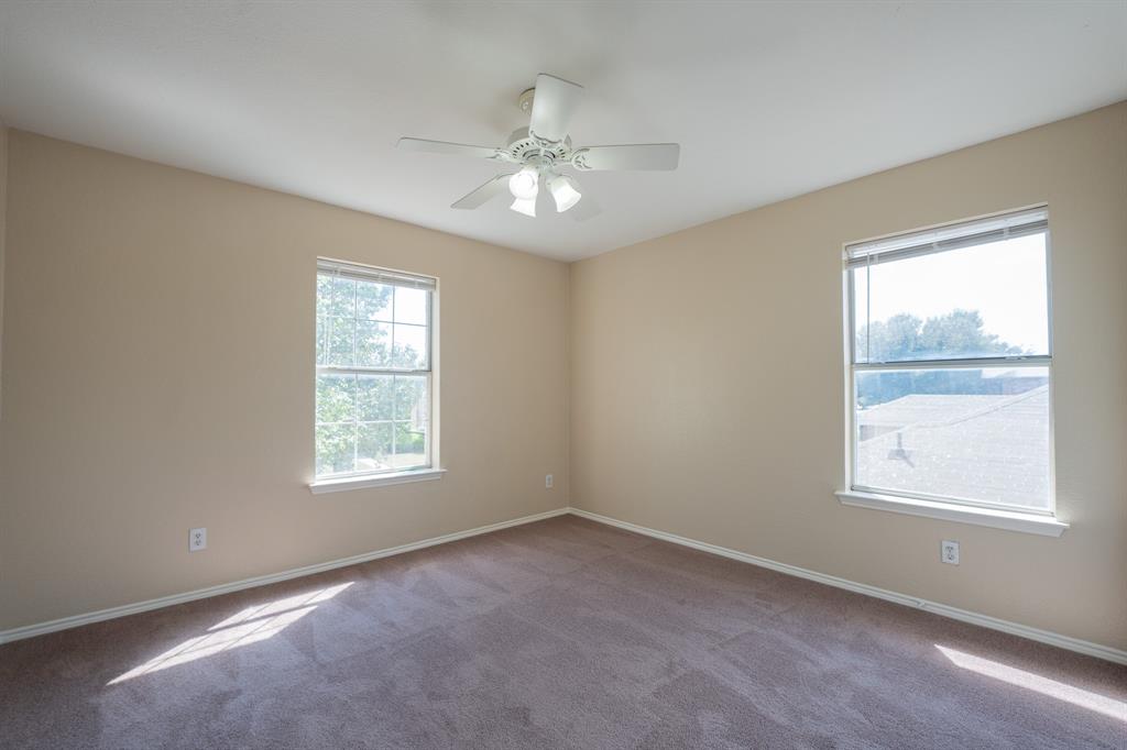 447 Maple Grove Drive Cedar Hill, TX 75104 - Photo 12 of 15 an empty room with a window and ceiling fan