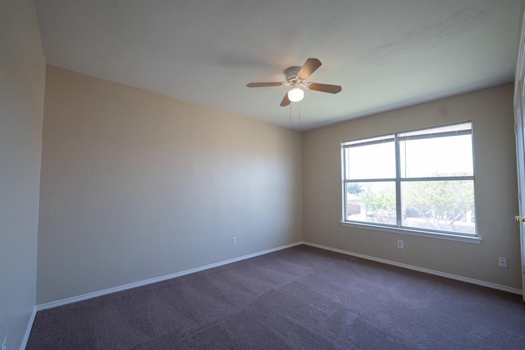 447 Maple Grove Drive Cedar Hill, TX 75104 - Photo 13 of 15 an empty room with a window and a ceiling fan