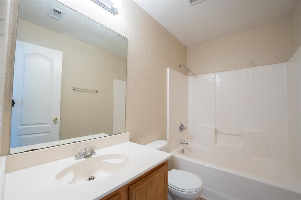 447 Maple Grove Drive Cedar Hill, TX 75104 - Photo 14 of 15 a bathroom with a sink a toilet and shower