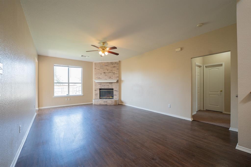447 Maple Grove Drive Cedar Hill, TX 75104 - Photo 2 of 15 an empty room with wooden floor chandelier and windows