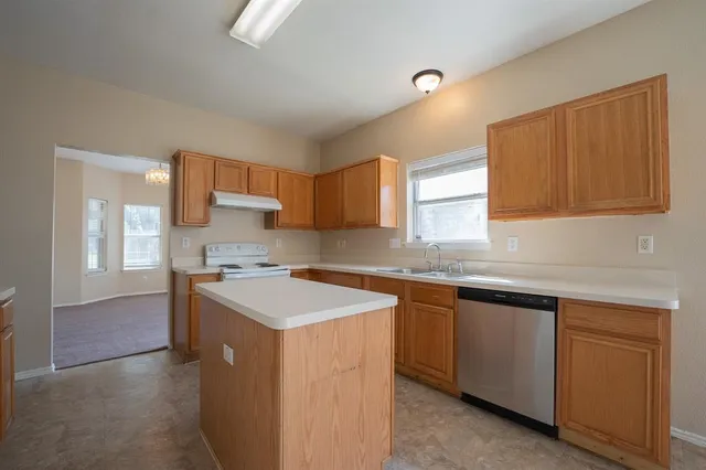 a kitchen with a sink stove and cabinets