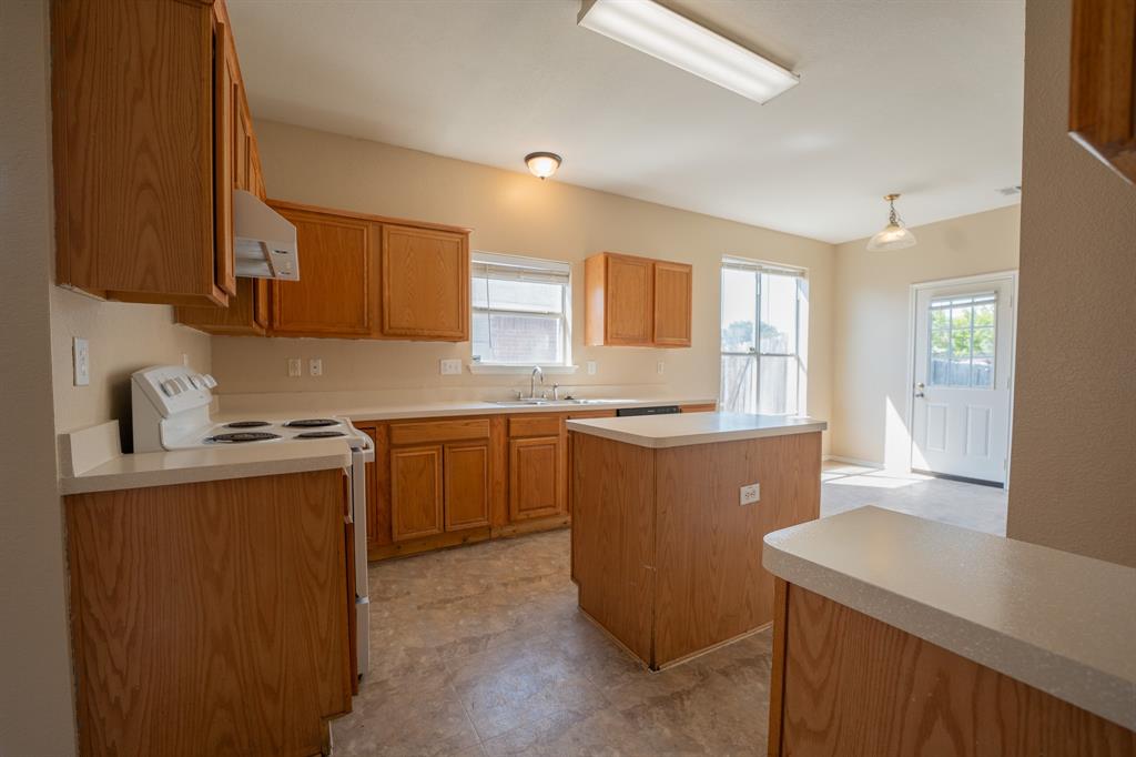 447 Maple Grove Drive Cedar Hill, TX 75104 - Photo 5 of 15 a kitchen with sink a stove and cabinets