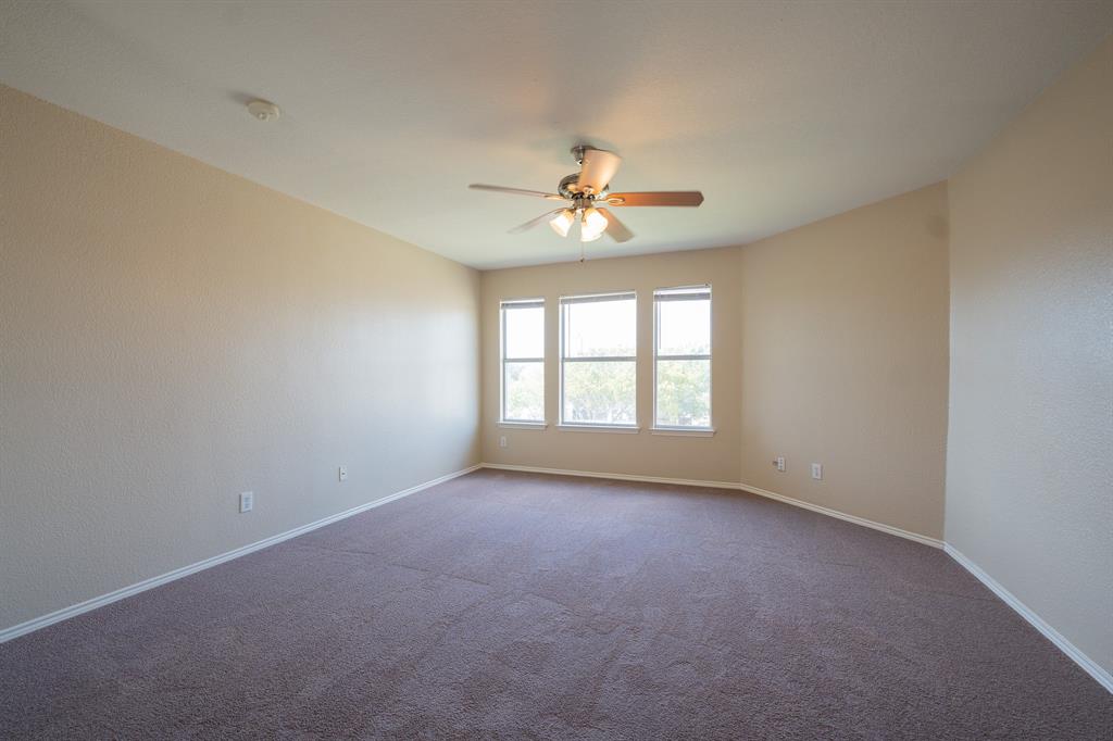 447 Maple Grove Drive Cedar Hill, TX 75104 - Photo 7 of 15 an empty room with a window and a ceiling fan