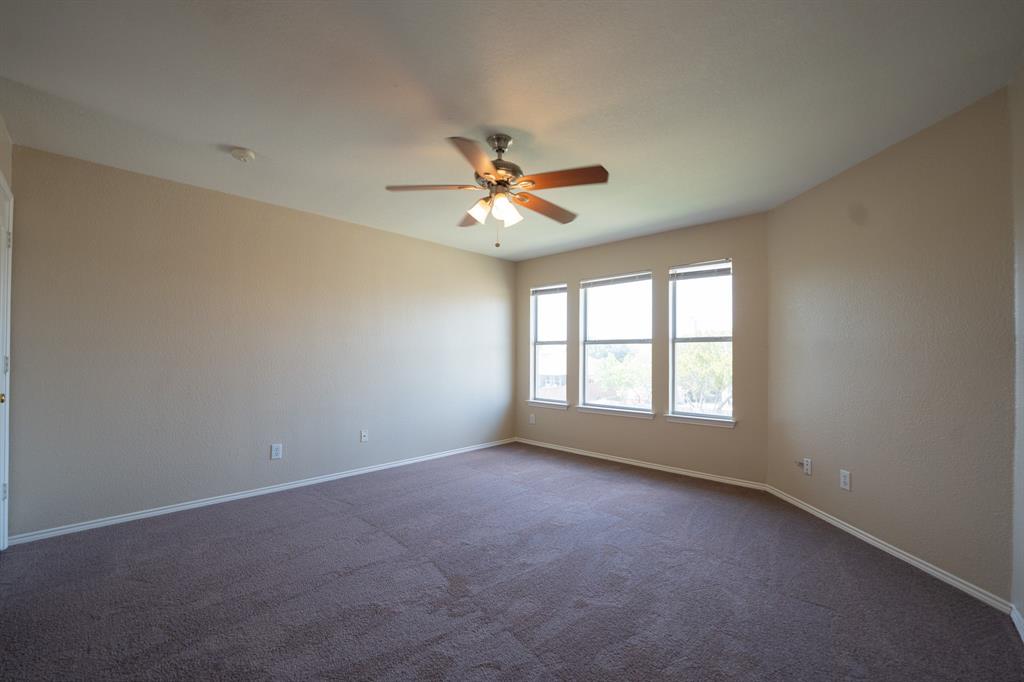 447 Maple Grove Drive Cedar Hill, TX 75104 - Photo 10 of 15 an empty room with chandelier fan and windows