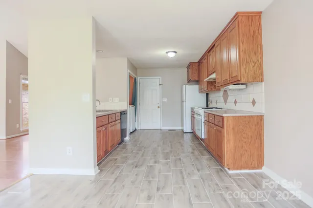 a view of a kitchen with a sink and cabinets