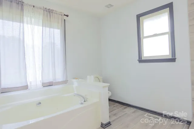 a white bath tub sitting next to a window